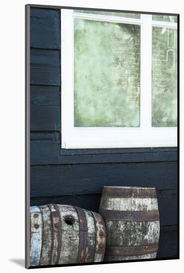 Rustic Barrels Lined Up Along an Old House Below a Window-Sheila Haddad-Mounted Photographic Print