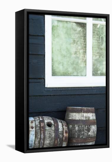 Rustic Barrels Lined Up Along an Old House Below a Window-Sheila Haddad-Framed Stretched Canvas