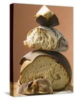 Rustic Bread, Two Loaves with Pieces Cut Off in a Pile-null-Stretched Canvas