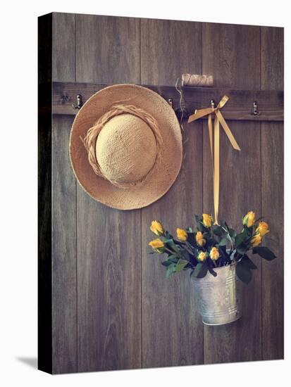 Rustic Shed Door with Hanging Straw Hat and Bucket of Yellow Roses-Chris_Elwell-Stretched Canvas