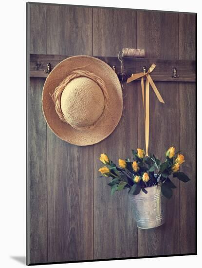 Rustic Shed Door with Hanging Straw Hat and Bucket of Yellow Roses-Chris_Elwell-Mounted Photographic Print