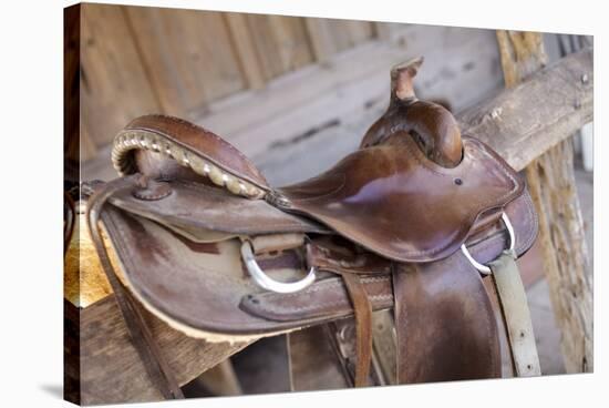 Saddle resting on the railing, Tucson, Arizona, USA.-Julien McRoberts-Stretched Canvas