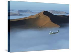 Safari Flights over Red Sand Dunes of Sossusvlei with Early Morning Mist, National Park, Namibia-Mark Hannaford-Stretched Canvas