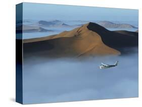 Safari Flights over Red Sand Dunes of Sossusvlei with Early Morning Mist, National Park, Namibia-Mark Hannaford-Stretched Canvas