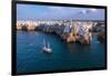 Sail boat anchored in the water off the white village of Polignano a Mare at sunset, Bari province-Paolo Graziosi-Framed Photographic Print