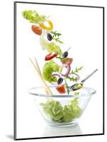 Salad Ingredients Falling into a Glass Bowl-Caroline Martin-Mounted Photographic Print