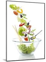 Salad Ingredients Falling into a Glass Bowl-Caroline Martin-Mounted Photographic Print