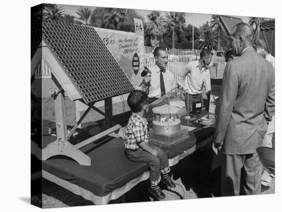 Salesman Demonstrating Solar Battery at the International Conference on Solar Energy-J^ R^ Eyerman-Stretched Canvas