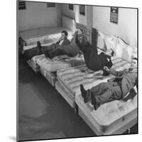 Salesmen Showing How Not to Test a Bed-null-Mounted Photographic Print