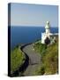 San Sebastian Bay Clifftop Lighthouse with Cyclist Riding Uphill-Christian Kober-Stretched Canvas