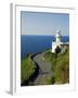 San Sebastian Bay Clifftop Lighthouse with Cyclist Riding Uphill-Christian Kober-Framed Photographic Print