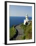 San Sebastian Bay Clifftop Lighthouse with Cyclist Riding Uphill-Christian Kober-Framed Photographic Print