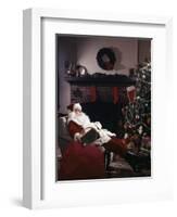 SANTA CLAUS ASLEEP IN CHAIR IN FRONT OF CHRISTMAS TREE AND FIREPLACE INDOOR-Panoramic Images-Framed Photographic Print