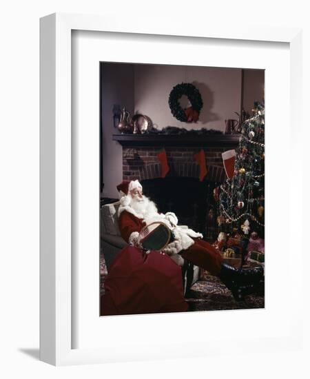 SANTA CLAUS ASLEEP IN CHAIR IN FRONT OF CHRISTMAS TREE AND FIREPLACE INDOOR-Panoramic Images-Framed Photographic Print