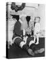 Santa Claus with a Little Boy and a Teddy Bear in Front of a Fire Place-null-Stretched Canvas