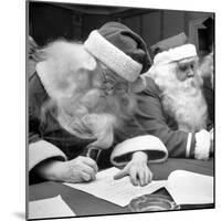 Santa Clauses Take a Written Examination For Diploma After Listening to Lectures-Martha Holmes-Mounted Photographic Print