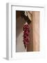 Santa Fe, New Mexico. Long, red chili, hanging from a wooden corbel and stucco wall-Jolly Sienda-Framed Photographic Print