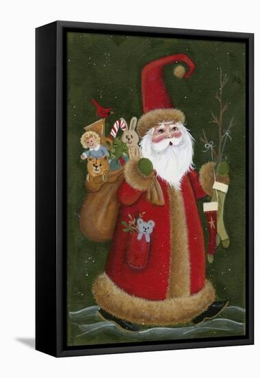 Santa Holding Toys and Stockings-Beverly Johnston-Framed Stretched Canvas