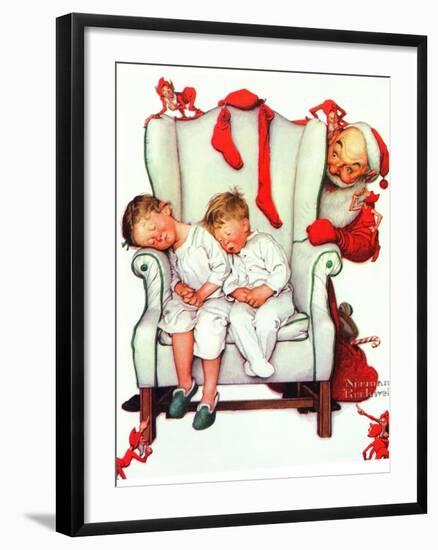 Santa Looking at Two Sleeping Children (or Santa Filling the Stockings)-Norman Rockwell-Framed Giclee Print