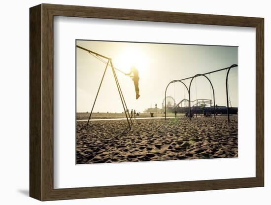 Santa Monica Beach. Silhouette of a Woman Going up with the Swing. Concept about Traveling,United S-Oneinchpunch-Framed Photographic Print