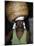 Sao Tomense Woman Carries Basket Full of Cocoa Beans, Cocoa Processing Plant in Agua Ize, Sao Tome-Camilla Watson-Mounted Photographic Print