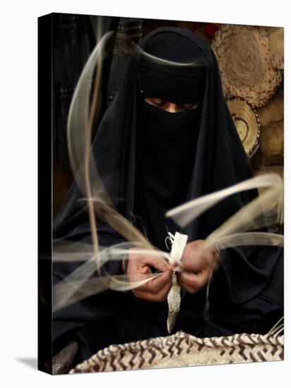 Saudi Woman Works to Demonstrate Her Craft as She Makes a Cane Box at a Fair in Riyadh-null-Stretched Canvas