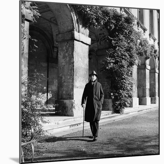 Scholar C.S. Lewis Walking with Cane Near Building at Magdalen College, Oxford University-Hans Wild-Mounted Premium Photographic Print