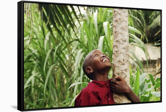 Schoolchild Embracing Tree Trunk and Looking Up, Bujumbura, Burundi-Anthony Asael-Framed Stretched Canvas