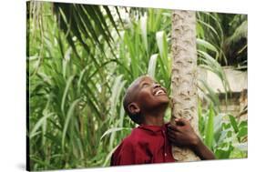Schoolchild Embracing Tree Trunk and Looking Up, Bujumbura, Burundi-Anthony Asael-Stretched Canvas
