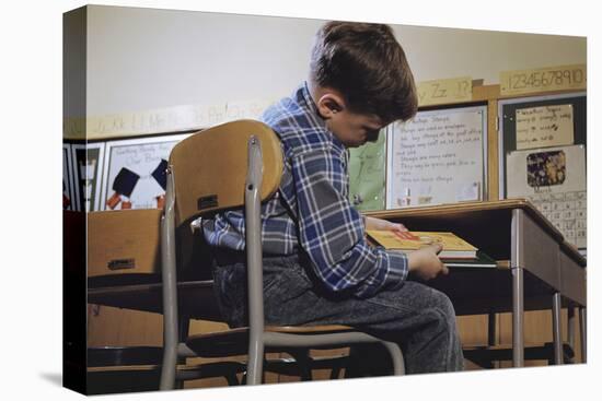 Schoolchild Placing Books in Desk-William P. Gottlieb-Stretched Canvas