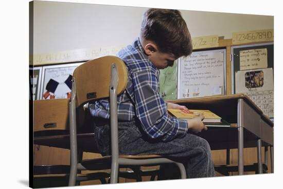 Schoolchild Placing Books in Desk-William P. Gottlieb-Stretched Canvas