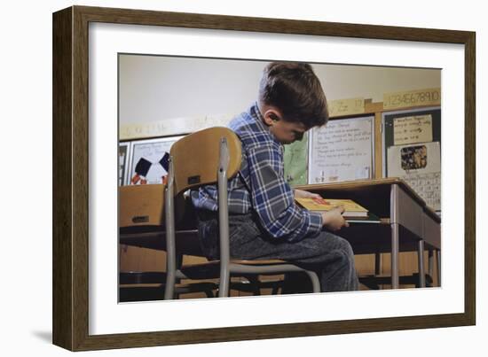 Schoolchild Placing Books in Desk-William P. Gottlieb-Framed Photographic Print