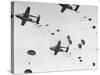 Scores of Paratroopers Dropping from C-82 "Flying Boxcar" and Landing on Level Ground-Frank Scherschel-Stretched Canvas