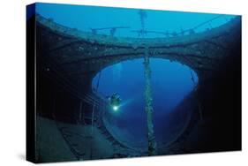 Scuba Diver Exploring a Shipwreck, Papua New Guinea, Coral Sea.-Reinhard Dirscherl-Stretched Canvas