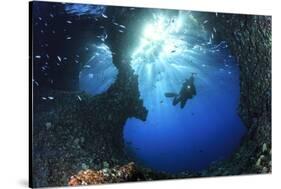 Scuba Diver Swimming through an Arch-Bernard Radvaner-Stretched Canvas