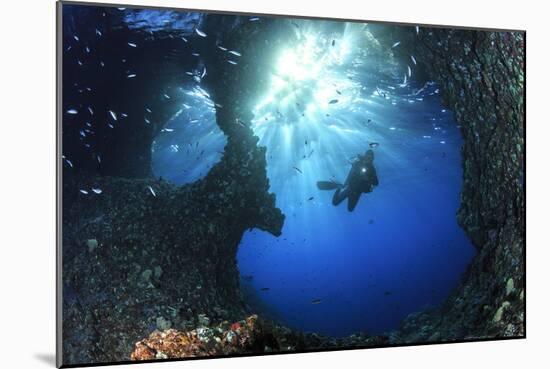 Scuba Diver Swimming through an Arch-Bernard Radvaner-Mounted Photographic Print