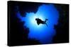 Scuba Diver Swims over Underwater Cave, Silhouette against Sun-Rich Carey-Stretched Canvas