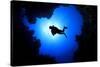 Scuba Diver Swims over Underwater Cave, Silhouette against Sun-Rich Carey-Stretched Canvas