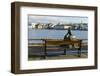 Sculpture of a man sitting on a park bench in front of Tjornin Lake and the Historic Centre of Rykj-Miles Ertman-Framed Photographic Print