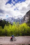 A Lone Cyclist Travels Along a Mountain Road with Trees and the Julian Alps in the Background-Sean Cooper-Framed Photographic Print