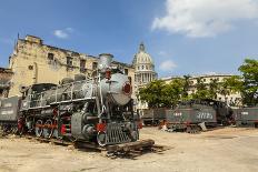 A Vintage Steam Train in a Restoration Yard with Dome of Former Parliament Building in Background-Sean Cooper-Photographic Print