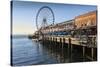 Seattle Great Wheel on Pier 57 in the foreground in late afternoon sunshine. Seattle, Washington St-Frank Fell-Stretched Canvas