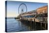 Seattle Great Wheel on Pier 57 in the foreground in late afternoon sunshine. Seattle, Washington St-Frank Fell-Stretched Canvas