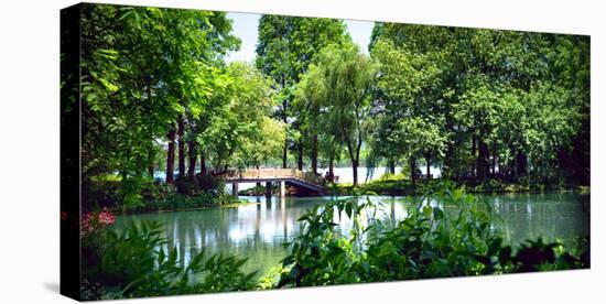 Secluded Stone Bridge Surrounded by Lush Landscape at West Lake, Hangzhou, Zhejiang, China-Andreas Brandl-Stretched Canvas