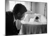 Sen. Jack Kennedy Admiring Baby Caroline as She Lies in Her Crib in Nursery at Georgetown Home-Ed Clark-Mounted Photographic Print