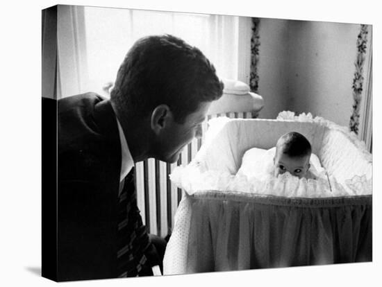 Sen. John F. Kennedy Playing Peek-A-Boo with His Daughter Caroline in Her Crib-Ed Clark-Stretched Canvas