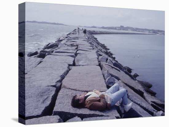 Senator Edward M. Kennedy Basking in Sun on Breakwater in Hyannis Port-John Loengard-Stretched Canvas