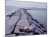 Senator Edward M. Kennedy Basking in Sun on Breakwater in Hyannis Port-John Loengard-Mounted Photographic Print
