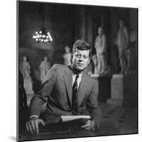 Senator John F. Kennedy Seated in Museum W. Statues-null-Mounted Photographic Print