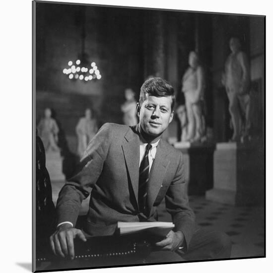 Senator John F. Kennedy Seated in Museum W. Statues-null-Mounted Photographic Print
